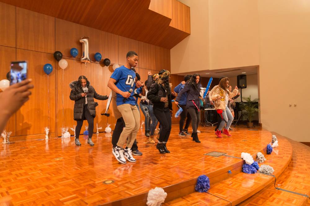 Image of students who attended event dancing to music as DJ gets the party started